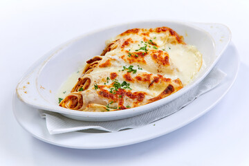 Cannelloni stuffed with spinach and ricotta cheese in a baking dish