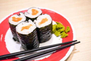 Various sushi platter in square ceramic plate on Japanese Restaurant. Concept for whole healthy food, nutrition, omega-3, animal protein, seafood, modern resto and street food. 