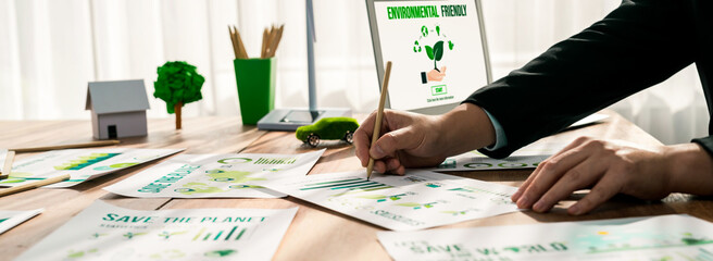 Businessman in green corporate company planning eco-friendly and environmental conservative to...
