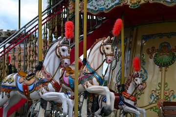 Fototapeta na wymiar Colourful children's carousel with horses in an amusement park. Empty old fashioned carrousel. Merry-go-round in Gdansk, Poland