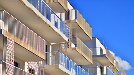 Fototapeta premium Modern luxury residential building. Modern apartment building on a sunny day. Facade apartment building with a blue sky. 