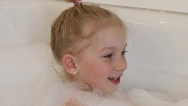 Girl taking a bubble bath.