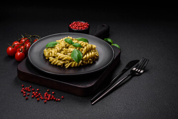 Delicious fresh pasta with green pesto sauce with basil