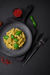 Delicious fresh pasta with green pesto sauce with basil