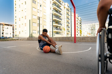 young black man holding on to a sprained ankle during a game, a sports injury