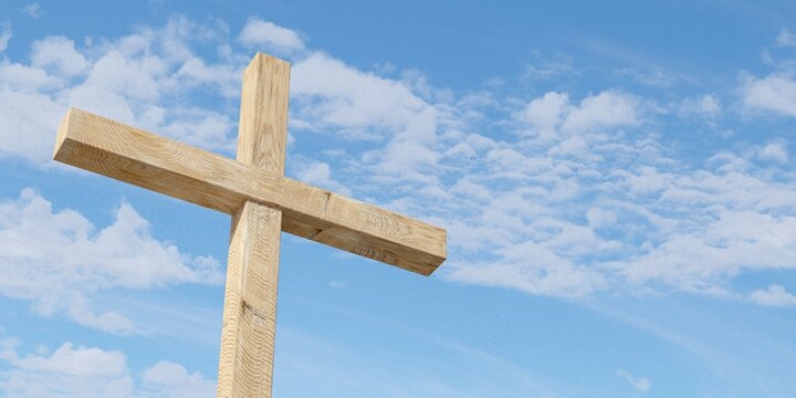 Jesus Christ christian crucifix or cross in front of blue sky with clouds, god, resurrection or christianity concept