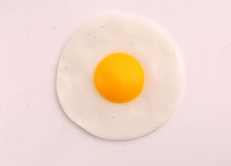 scrambled eggs from a single egg on a gray background