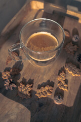 Top view of a cup of coffee. German Lebkuchen cookies. Coffee flat lay. Cookies in the shape of autumn leaves. Autumn background. Photo from the coffee shop. Appetizing still life. Warm colors.