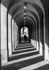 Black and White image  of man walking in a corridor at Manchester Town Hall, UK