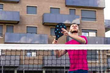 Man preparing to spike the ball in Pickleball. In Pickleball, it is prohibited to volley (hit the ball without first touching the ground) with any foot inside the zone or touching the No-volley line.