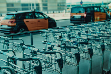 Airport carts and taxi on background