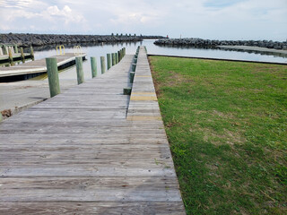 Obraz premium Wooden sidewalk and pier. Pathway to the beach in summer.