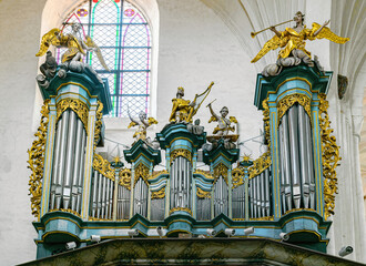 Ancient musical pipe organ in a gothic church - obrazy, fototapety, plakaty