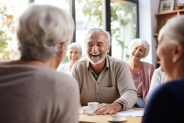 Group of senior men and women sitting around a table laughing and talking