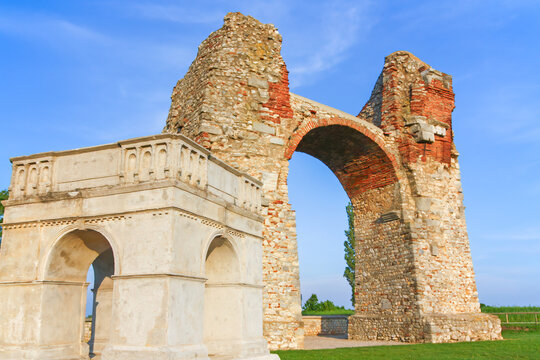 Old Roman City Gate (Heidentor) at Carnuntum in Austria, Europe. The model of the original building is in the foreground. Horizontally. 