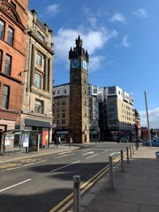 The Glasgow Tolbooth Steeples , classic tower topped by a clock and a stone crown around Glasgow Cross 