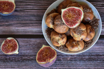 Delicious homemade profiteroles cakes with cocoa cream filling and chocolate chips on plate, fig...