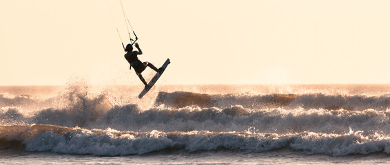 kite surfer jumping over the waves  - Powered by Adobe