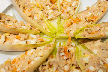 cichorium endive leaves stuffed with chaca with tuna egg crab sticks - obrazy, fototapety, plakaty