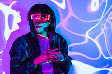 Amazed futuristic afro man wearing an augmented reality goggles