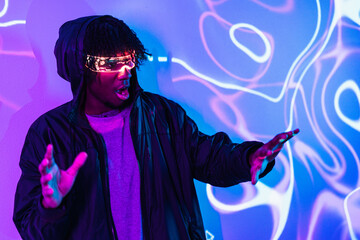 Shocked afro man using augmented reality goggles