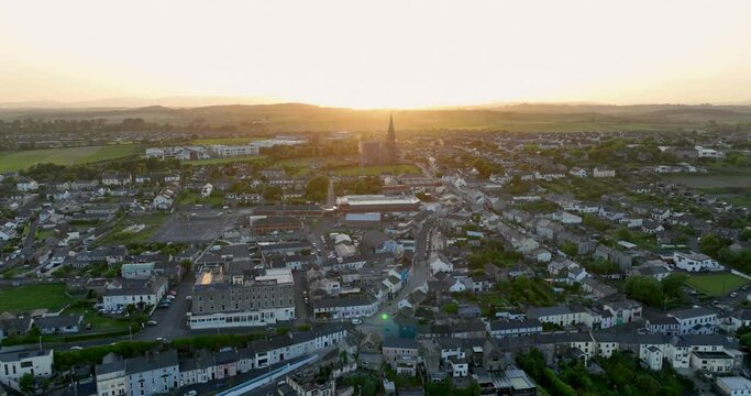 The city of Tramore at sunset. The camera flies towards the setting sun 4k