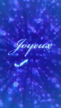 Merry Christmas in French, Joyeux Noel. Loopable between 9:00-13:00. Blue snowflakes background. Written with magical fairy dust particle effect. Vertical video.