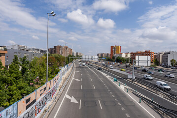 Side lanes of the M-30 ring road in the city of Madrid Spain on a day with the sky full of clouds