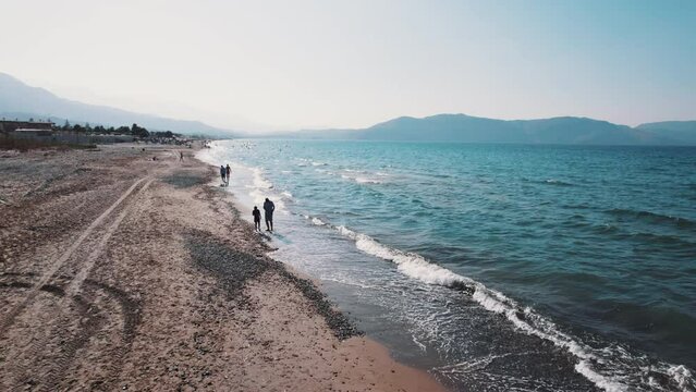 people relaxing on Kavros beach during summer holidays, aerial drone shot. High quality 4k footage