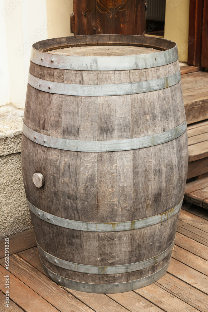 Wall mural Traditional wooden barrel on street outdoors. Wine making