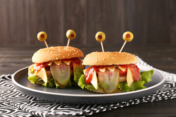 Cute monster burgers on table. Halloween party food - Powered by Adobe