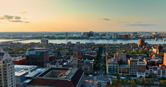 Stunning low-rise city architecture on the river bank. Scenery of Boston at sun down from top.