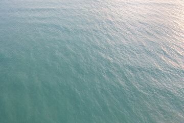 Aerial view of clear blue turquoise seawater, Andaman sea in Phuket island in summer season, Thailand. Water in ocean pattern texture wallpaper background.