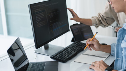 Two developer programmer checking code and writing note while programming to developing web and app