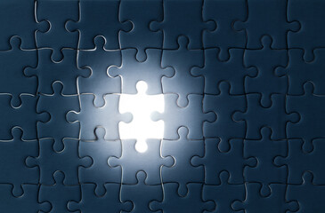 Solving the puzzle of success Illuminating concepts in Business. White jigsaw puzzle with missed...