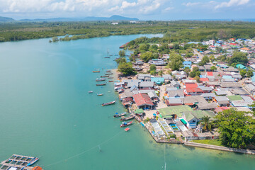 Aerial top view of tourist boats in beach shore, river, pond or lake in summer season. Nature landscape background, Thailand.