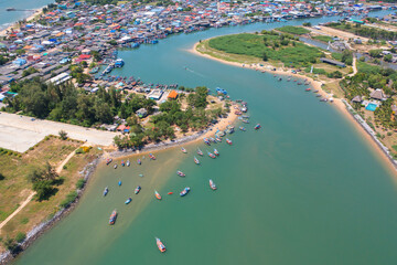 Fototapeta na wymiar Aerial top view of tourist boats in beach shore, river, pond or lake in summer season. Nature landscape background, Thailand.