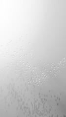 白とグレーの背景に透明の美しい水滴。流れるように舞う。（縦長）
