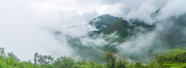 Panoramic view of cloud swirling around a high mountain range near Sapa in Vietnam