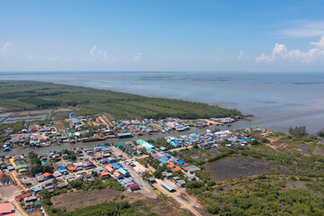 Aerial view of fishing trap net in canel with fisherman urban city village town houses, lake or river. Nature landscape fisheries and fishing tools at Pak Pha, Songkhla, Thailand. Aquaculture farming