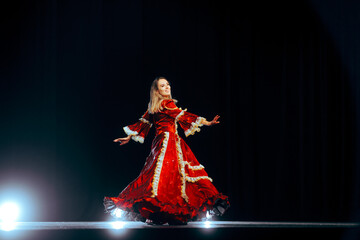 Happy Actress Wearing a Princess Dress Dancing on the Stage. Talented woman wearing a theater costume doing a pirouette 
