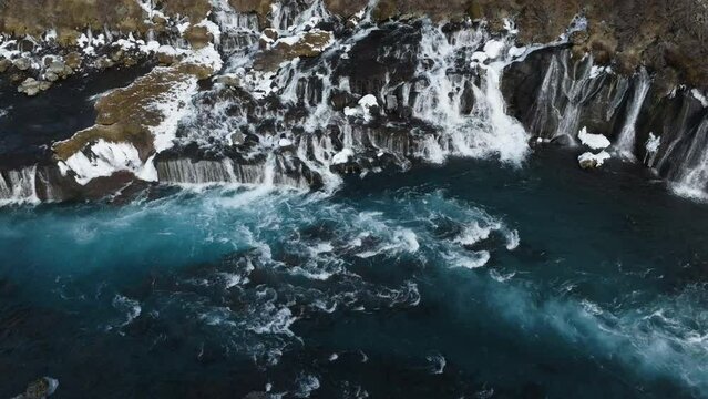 Aerial view around the rapids in front of the Hraunfossar waterfall, winter in Iceland