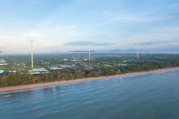 Aerial view of wind turbines or windmills farm field and sea shore beach in industry factory. water...