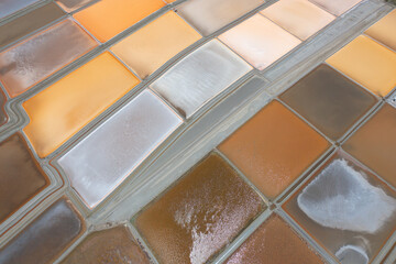 Aerial view of natural sea salt ponds, lake or sea. Farm field outdoor in traditional industry in Thailand. Asia culture. Agriculture irrigation. River reflection.