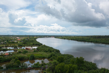 Fototapeta na wymiar Aerial top view of a garden park with green mangrove forest trees, river, pond or lake. Nature landscape background, Thailand.