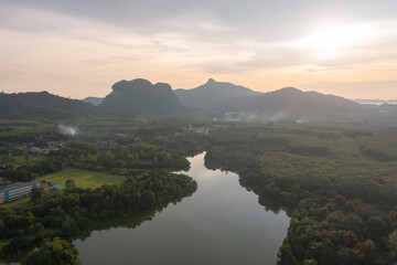 Obraz premium Aerial top view of a garden park with green mangrove forest trees, river, pond or lake. Nature landscape background, Thailand.