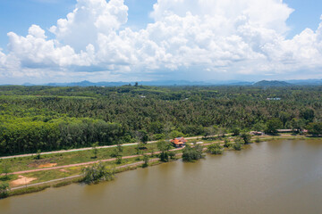 Aerial top view of a garden park with green mangrove forest trees, river, pond or lake. Nature landscape background, Thailand.