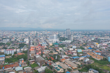 Fototapeta premium Aerial view of residential neighborhood roofs. Urban housing development from above. Top view. Real estate in Phuket, southern province city, Thailand. Property real estate.