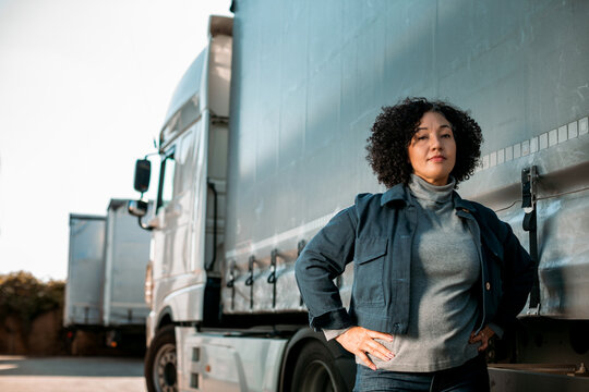 Portrait of a middle aged female truck driver working for a trucking company