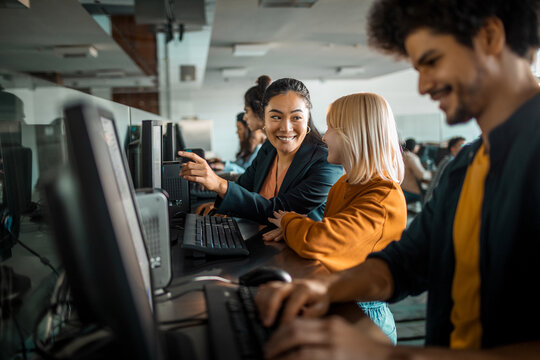 Diverse group of students studying and working on their projects on a computer in the college or university